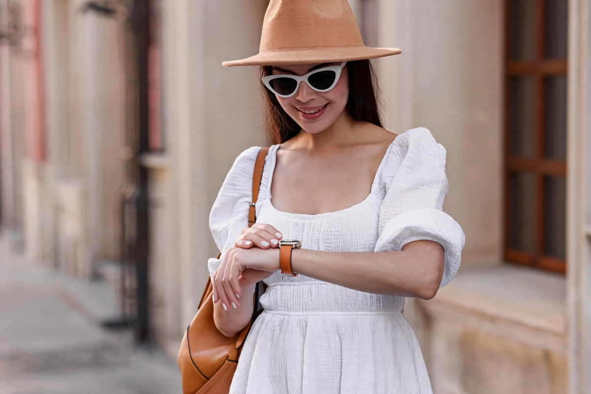woman is wearing an orange apple watch band