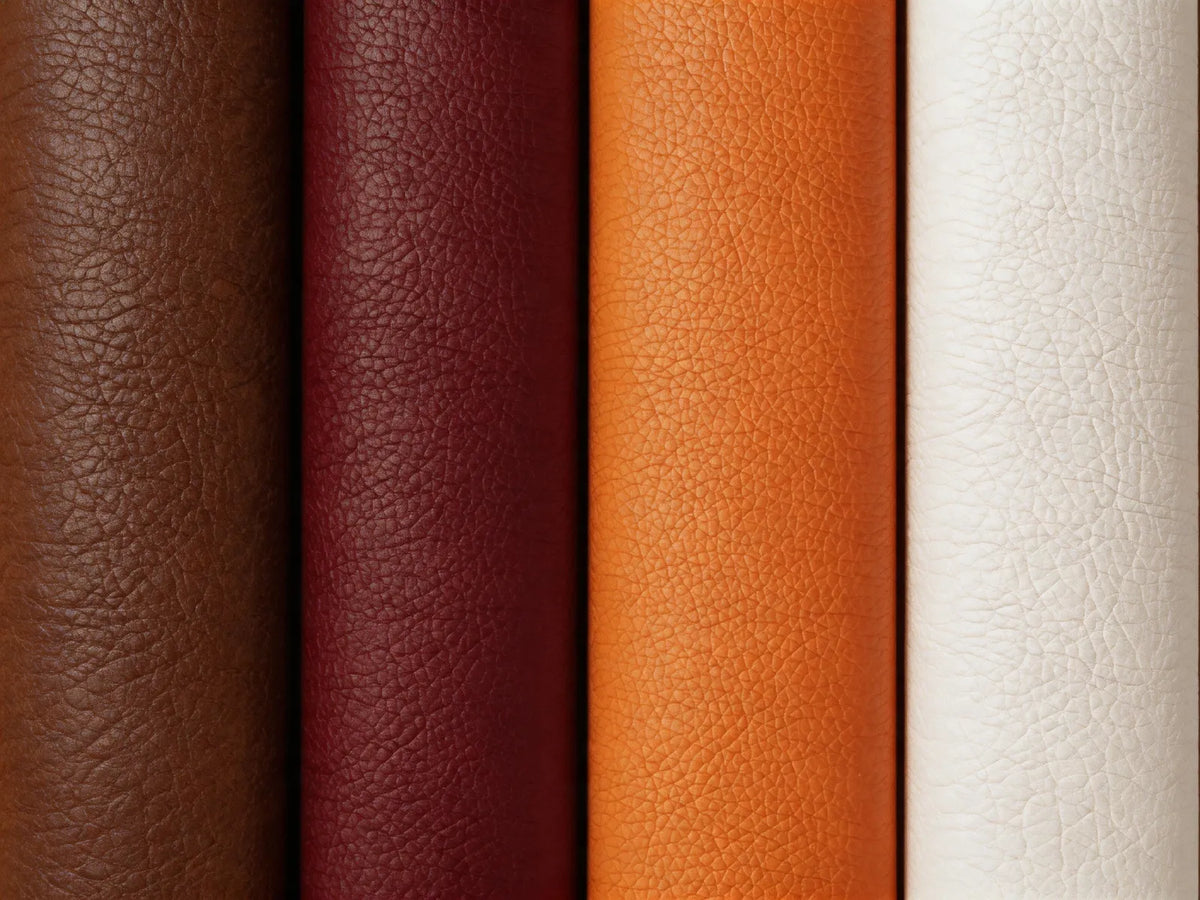 Four vertical leather material swatches in brown, burgundy, orange, and off-white, showing a pebbled texture.