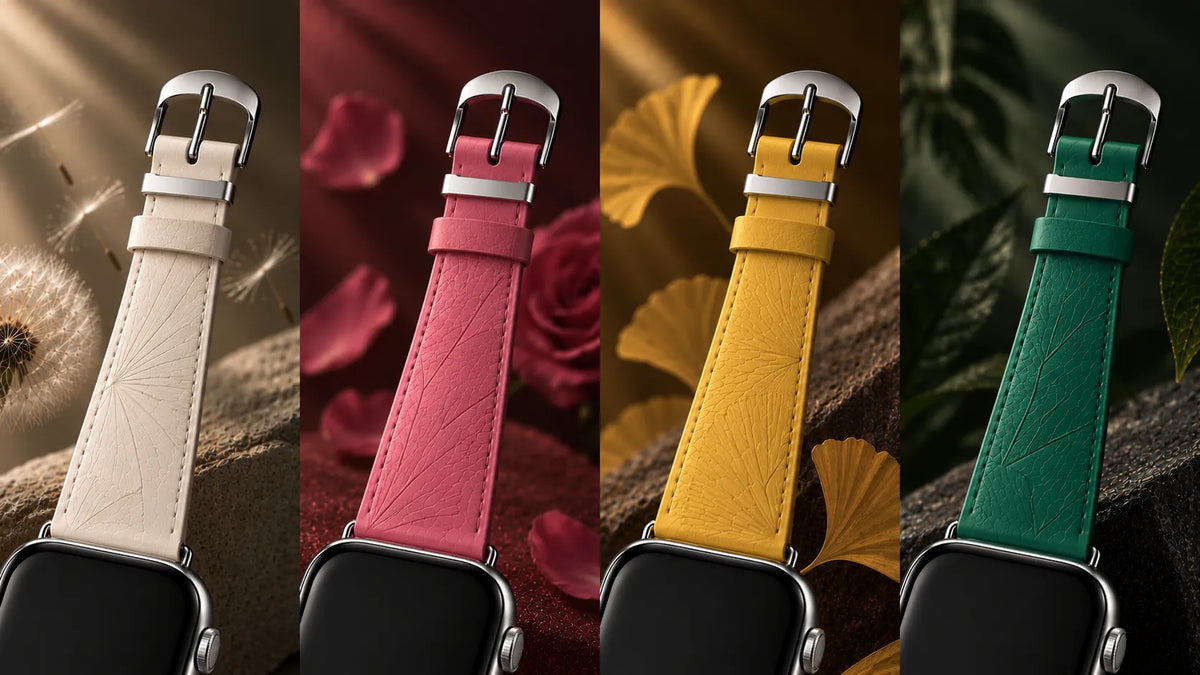 Four leather watch straps shown on smartwatches, each in a different color: off-white, pink, mustard yellow, and teal green. The straps feature an embossed leaf pattern and silver-toned metal hardware, set against stylized backgrounds with flowers, leaves, and bark.